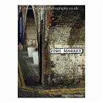 Atmospheric shot of a sign for a fish market under an arch. Folkestone, England.